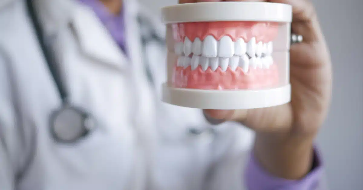 Dental professional holding denture model showing how modern dentures have come a long way with advanced technology and natural appearance